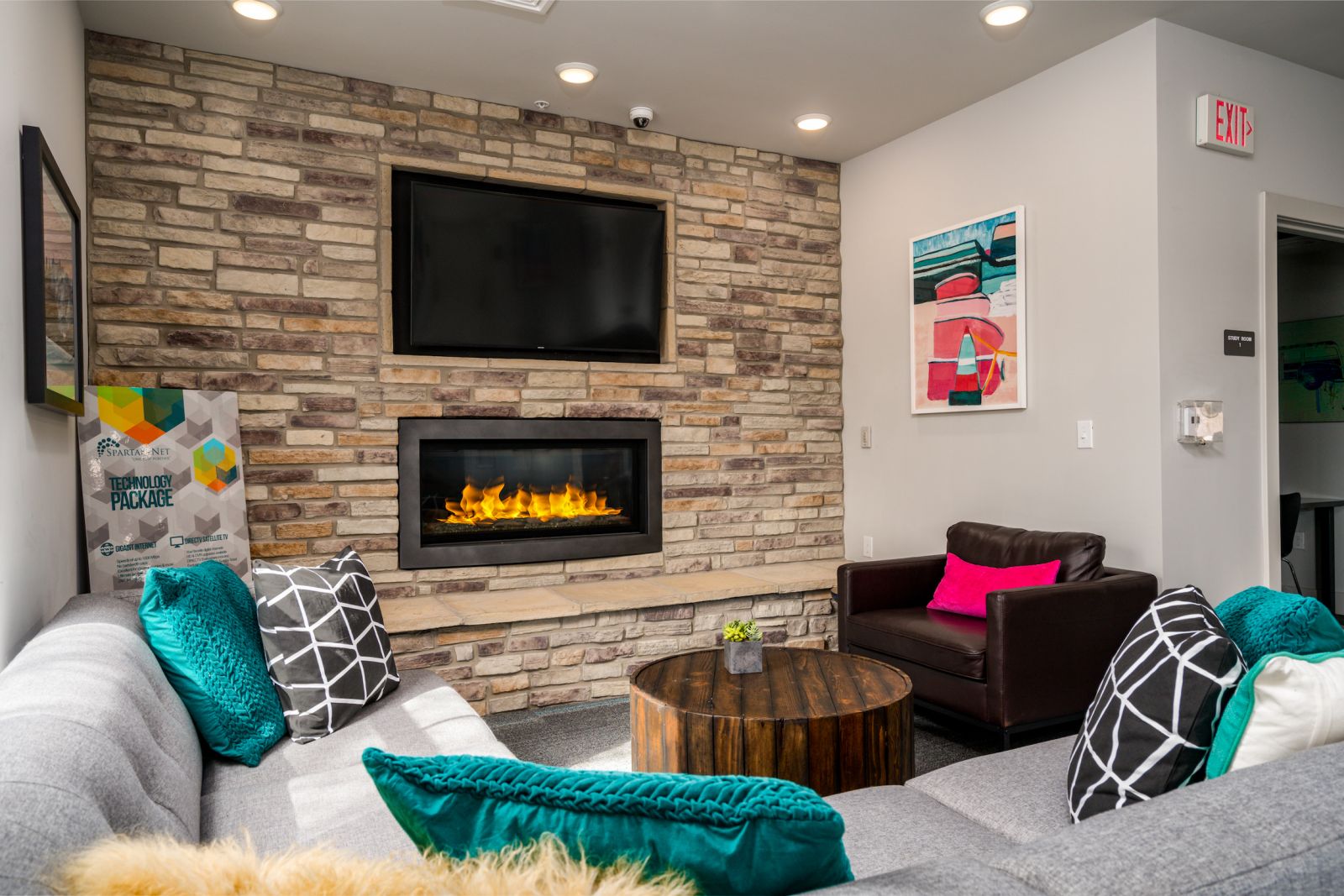 community lounge with stone fireplace